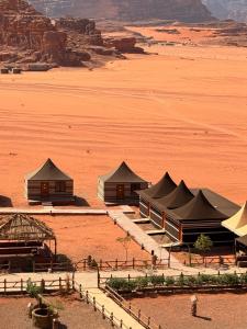 a group of tents in the middle of a desert at Jouri Luxury rum camp in Disah