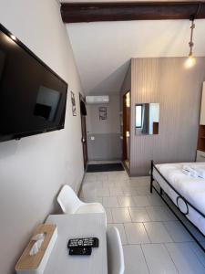 a room with a bed and a tv on a wall at B&B Garzola in Ossuccio
