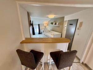 a kitchen with two chairs and a counter top at Studio du Vieux Marché in Romorantin