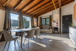 a kitchen and living room with a table and chairs at Suite Home Ferrara in Ferrara