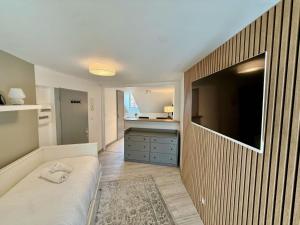 a bedroom with a large flat screen tv on a wall at Studio du Vieux Marché in Romorantin +5 photos