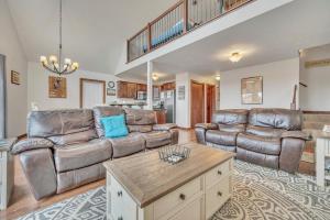 a living room with two leather couches and a coffee table at Bridges Bay Vacation Cabin 115 in Arnolds Park