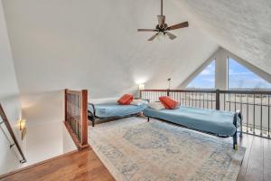a living room with two beds and a balcony at Bridges Bay Vacation Cabin 115 in Arnolds Park +24 photos