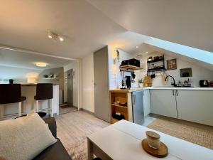 a kitchen and living room with a couch and a table at Studio du Vieux Marché in Romorantin