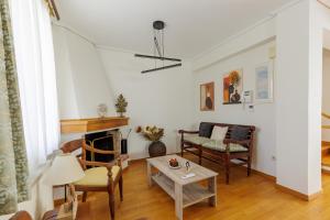 a living room with a table and chairs at Villa Elysia in Porto Rafti