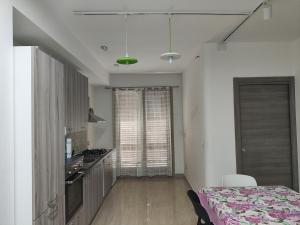 a room with a kitchen with a table and a stove at Heidi's home in Villabate