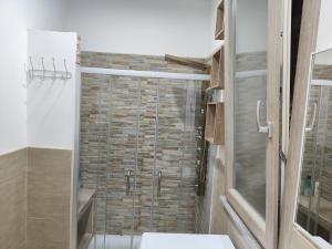 a bathroom with a shower with a glass door at Heidi's home in Villabate