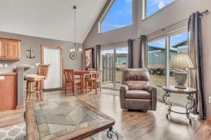 a living room with a chair and a table at Bridges Bay Vacation Cabin 69 in Arnolds Park