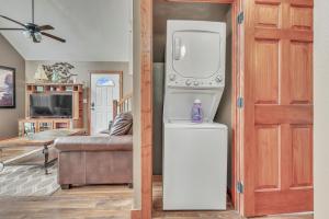 a kitchen with a refrigerator and a living room at Bridges Bay Vacation Cabin 69 in Arnolds Park