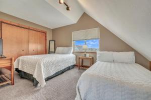 a bedroom with two beds and a window at Bridges Bay Vacation Cabin 69 in Arnolds Park +15 photos