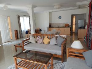 a living room with a couch and a table at Djerba Beach Haven in Aghīr