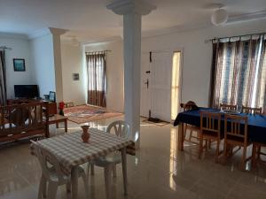 a living room with a table and a dining room at Djerba Beach Haven in Aghīr