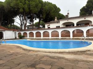 a swimming pool in front of a house at Casa Calma in L'Escala