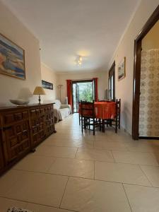 a living room with a table and a dining room at Casa Calma in L'Escala