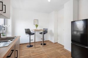 a kitchen with a table and two chairs and a tv at P & A Ferienwohnung in Soltau