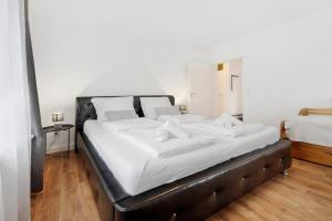 a bedroom with a large bed with white sheets at P & A Ferienwohnung in Soltau
