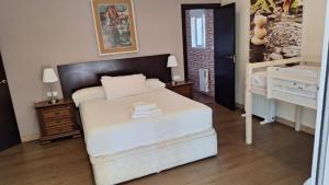 a bedroom with a large white bed in a room at Chalet La Serreta in Alicante +15 photos