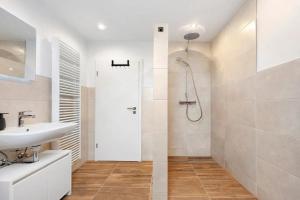 a white bathroom with a shower and a sink at P & A Ferienwohnung in Soltau