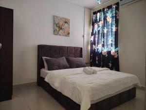 a bedroom with a bed with a brown headboard at EcoHill Serenity Suites in Semenyih +24 photos