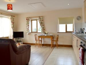 a living room with a couch and a table at The Smithy - Op6 in Carmarthen