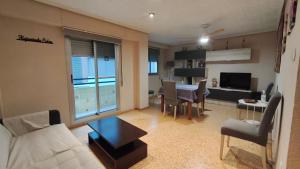 a living room with a couch and a dining room at Piso Colon in Paiporta