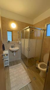 a bathroom with a shower and a sink and a toilet at בית נעים בין המדבר לים in Eilat +18 photos