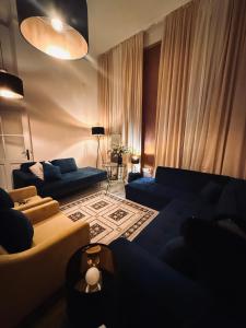 a living room with two blue couches and a living room with at CpB3 in Bratislava