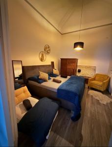 a bedroom with two beds and a couch at CpB3 in Bratislava