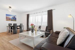 a living room with a couch and a table at P & A Ferienwohnung in Soltau +15 photos