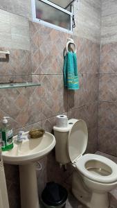 a bathroom with a toilet and a sink at House on Hermenegildo Beach in Santa Vitória do Palmar +30 photos