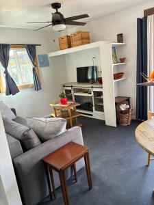 a living room with a couch and a tv at Painted sky casita in San Diego