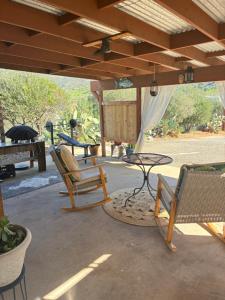 an outdoor patio with chairs and a table at Painted sky casita in San Diego