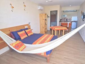 a bedroom with a bed and a hammock at Casa Flores de Mayo in Chicxulub +13 photos