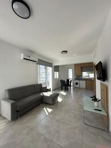 a living room with a couch and a table at Ocean Breeze 2BR House in Paralimni