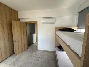 a small room with two bunk beds and a hallway at Ocean Breeze 2BR House in Paralimni