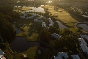 an aerial view of a golf course next to a lake at Tee Time Tranquility in Zephyrhills