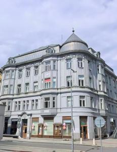 a large gray building on a city street at Ostrava Apartment in Ostrava