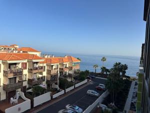 an aerial view of a street with buildings and the ocean at Cozy Studio with Seaview in Costa Del Silencio