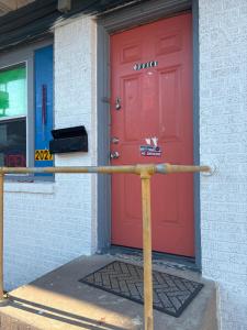 a pole in front of a red door at Rosenberg Motel in Galveston +11 photos