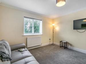 a living room with a couch and a flat screen tv at Dawson Park 9 - Uk12668 in Mablethorpe +16 photos
