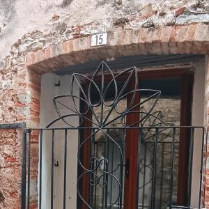a door with a wrought iron fence in front at L'epicurisme in Lorgues