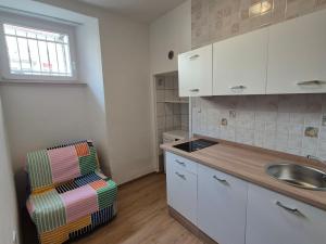a kitchen with a sink and a chair in a room at ReginaMare Santa in Piran +20 photos