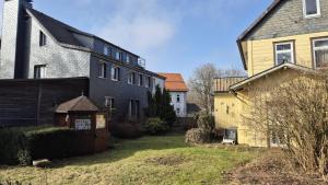 a group of houses in a yard next to a house at Steigerstube in Clausthal-Zellerfeld