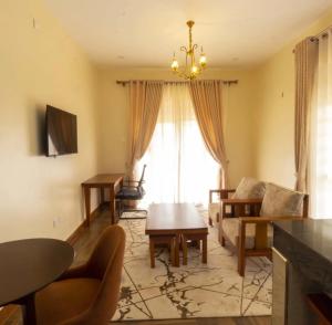 a living room with a couch and a table at SH Mukudo in Tororo