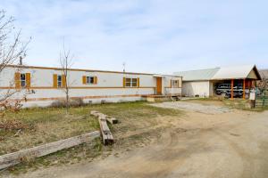 a large white building with a barn in the background at Walk to Loop Trail! East Wenatchee Basecamp in East Wenatchee