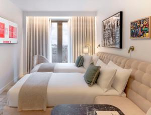 a hotel room with two beds and a couch at Gust hotel in Marrakesh