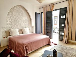 a bedroom with a large bed with a red blanket at Gust hotel in Marrakesh