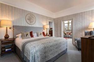 a bedroom with a large bed and a living room at Gust hotel in Marrakesh