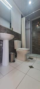 a bathroom with a sink and a toilet and a shower at Cesare in Uyuni
