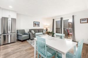 a kitchen and living room with a white table and chairs at Modern Style Third Floor Condo with Private Balcony in Bend
